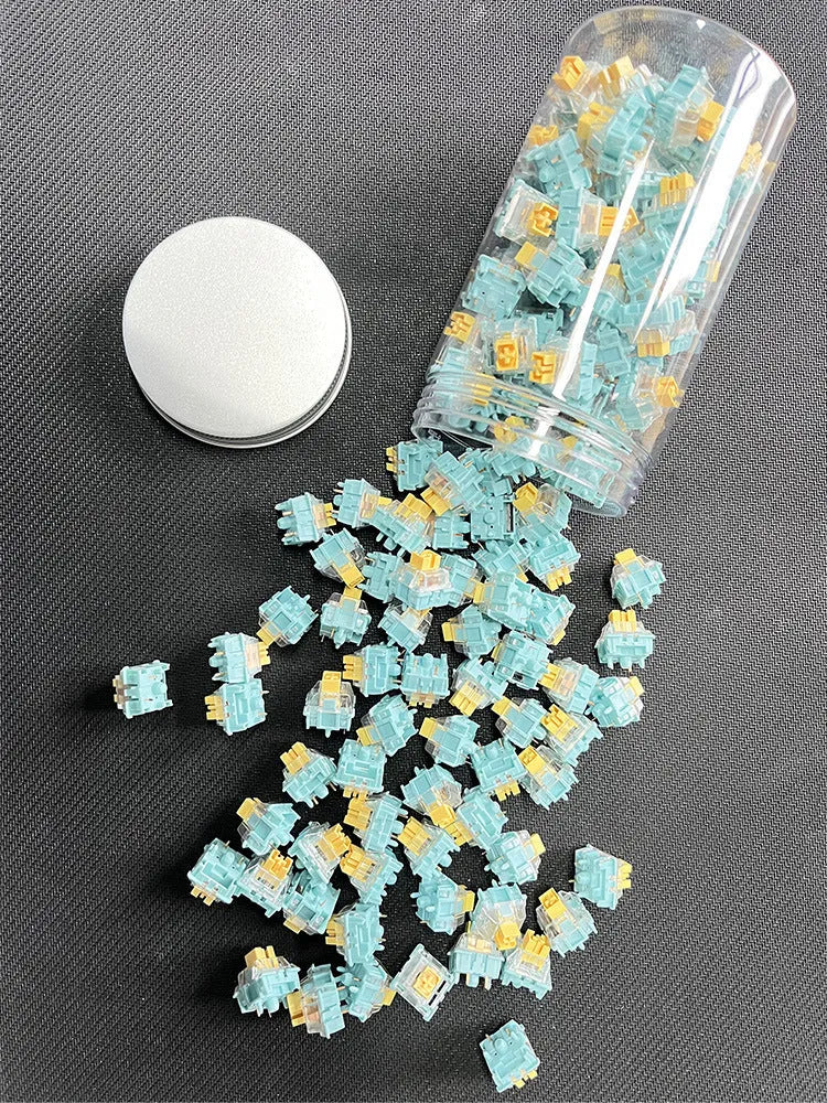 36 clear mechanical keyboard switches with Sea Salt Lemon coloured stems arranged in packaging.