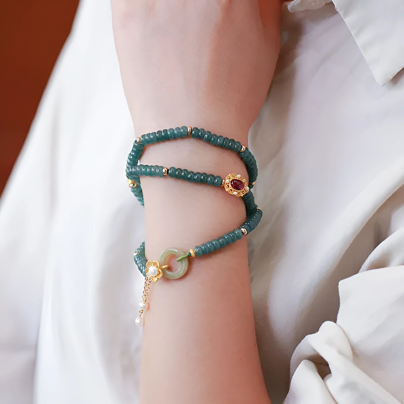 Blue water jade abacus beads bracelet with tourmaline and pearl three-ring design on wrist