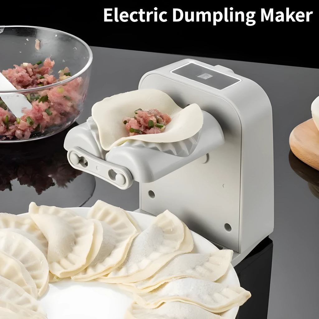 White automatic electric dumpling maker machine on a kitchen counter with USB cable and accessories