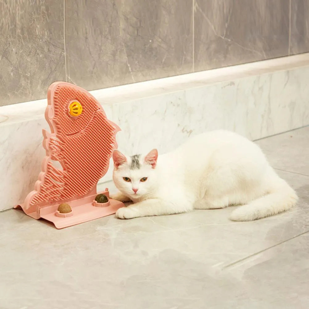Blue fish-shaped cat wall scratcher with self-grooming brush and two green catnip balls on a base