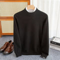Man wearing a loose-fit half-turtleneck wool sweater in a neutral colour.