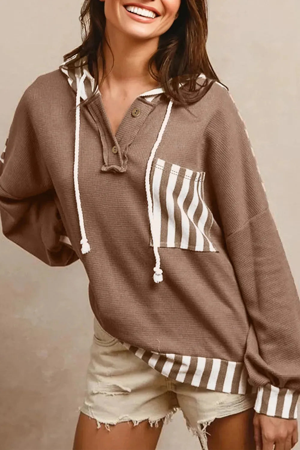 Straw yellow women's hoodie with waffle texture, patchwork stripes, a drawstring hood, and button neck.