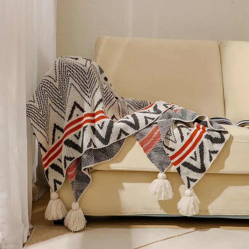 Bohemian style acrylic sofa throw blanket with tassel trim in a geometric pattern colour