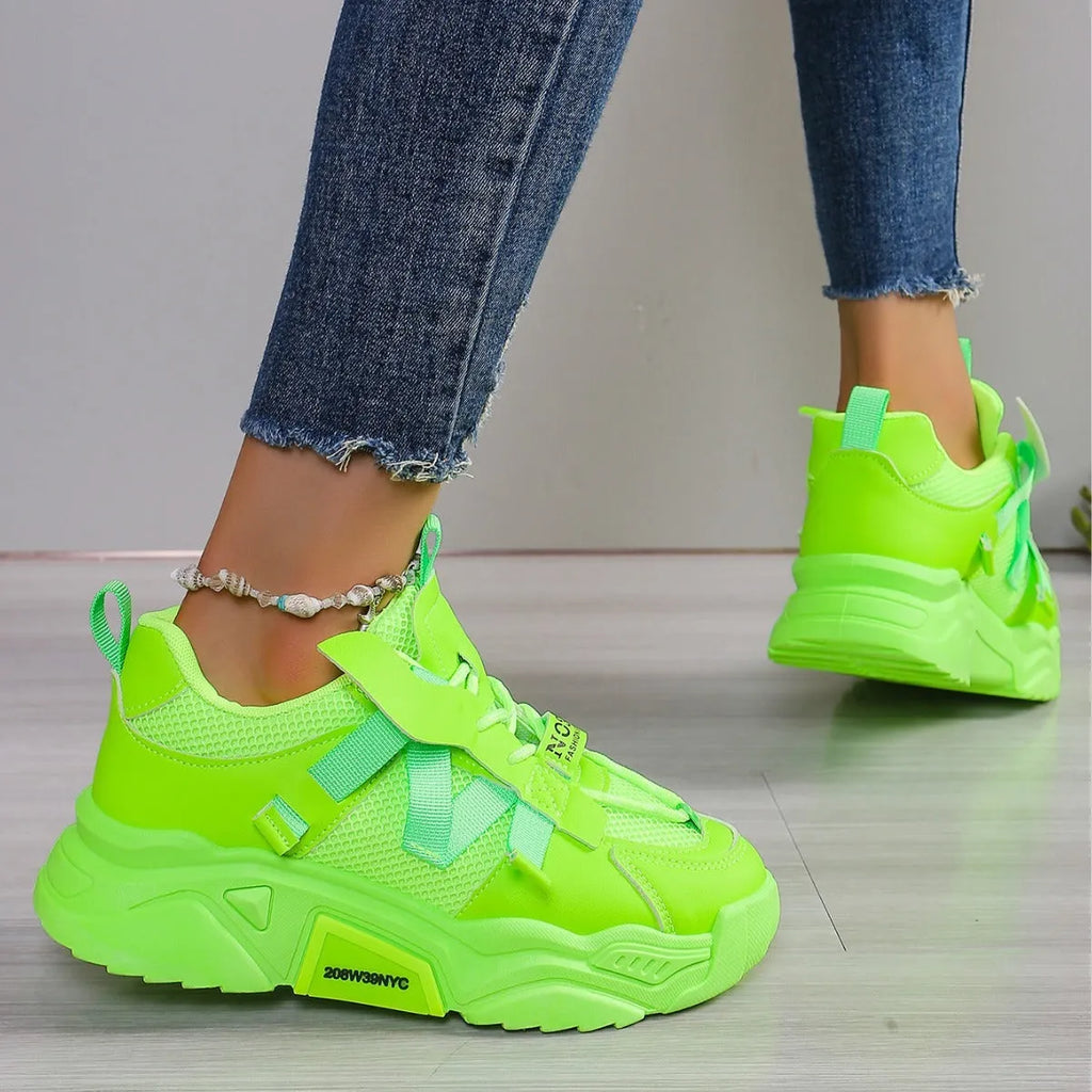 Women's purple platform mesh dad shoes with lace-up front, shown on a fitness floor.