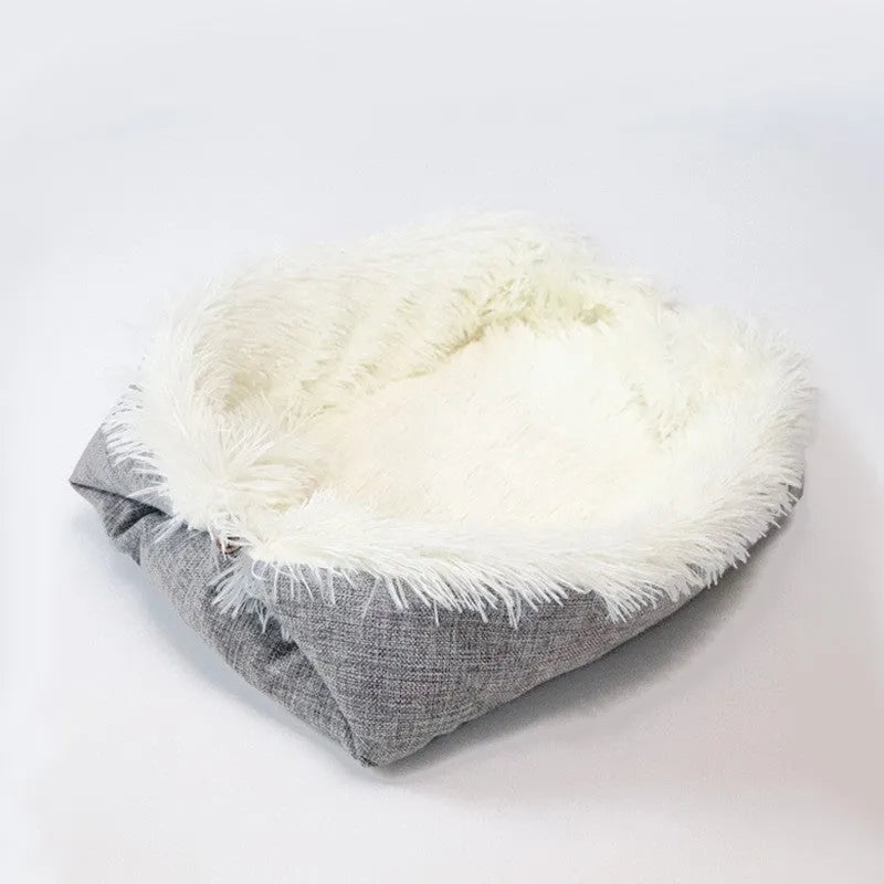 Two purpose gray pet blanket nest with long plush top and black non-slip bottom on a sofa