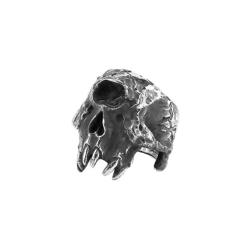 Close-up of a silver-toned alloy ring featuring a detailed one-eyed skull design on a finger.