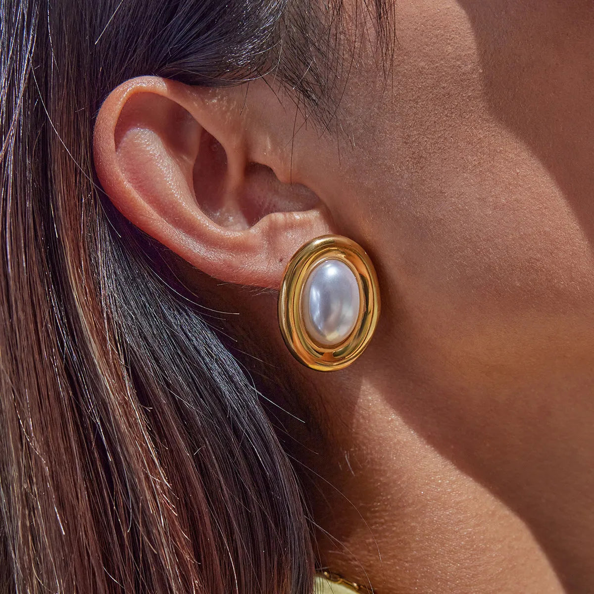 A pair of stainless steel vintage-style pearl stud earrings for women with an electroplated finish.