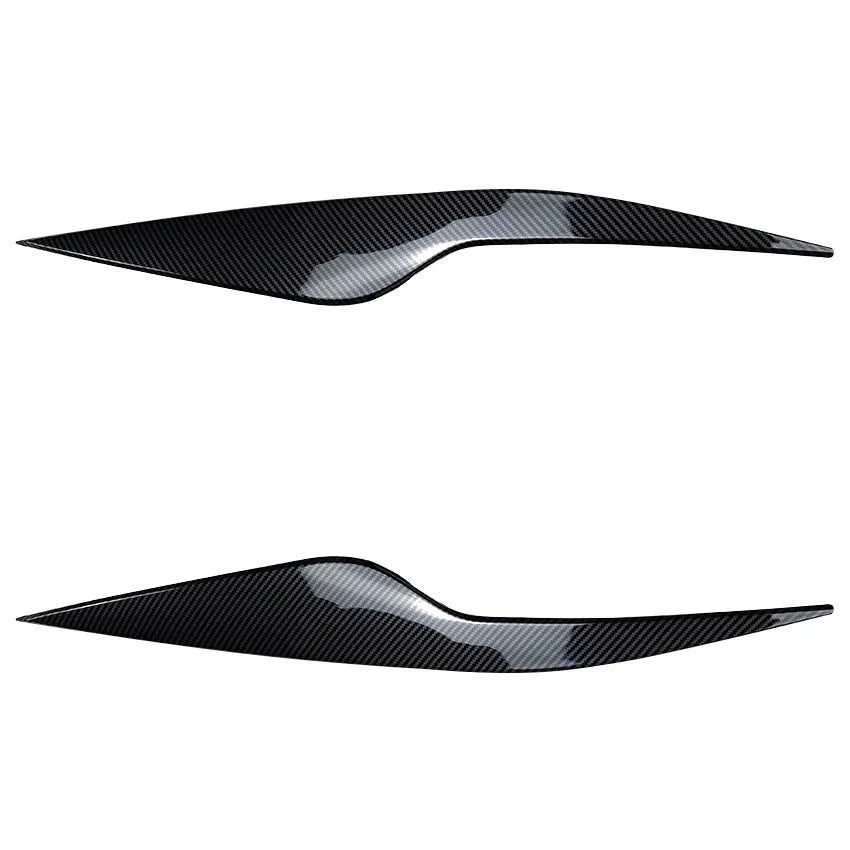 Ford Focus headlight sticker in carbon fiber pattern applied as external eyebrow trim on a car headlight