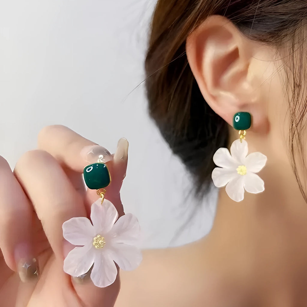 A pair of dark green alloy earrings with a sweet needle flower design on a white background.