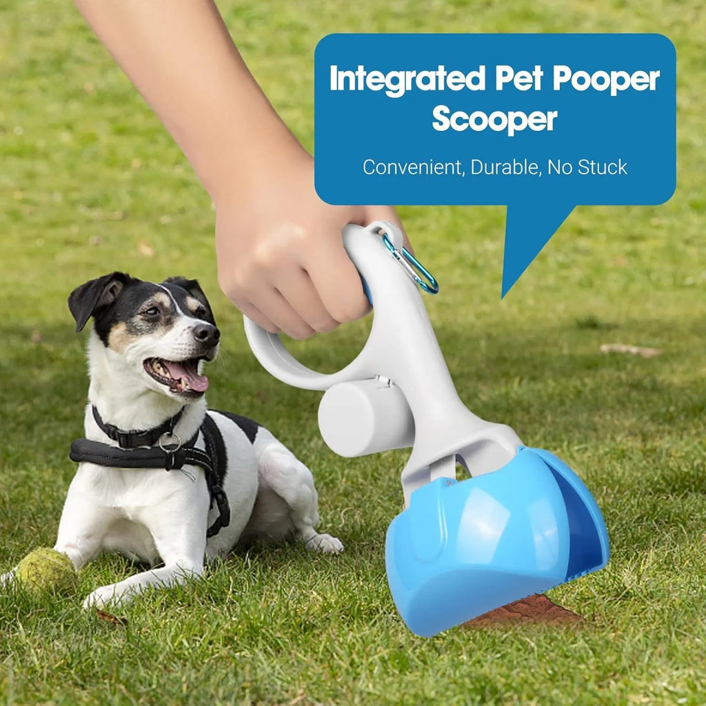Black pet pooper scooper with built-in bag holder and top carry hook on a grassy background.