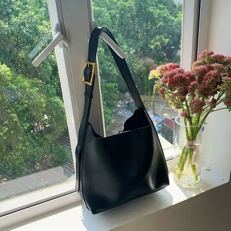 Women's soft PU shoulder bag with swing threads in black ribbon or brown colour options