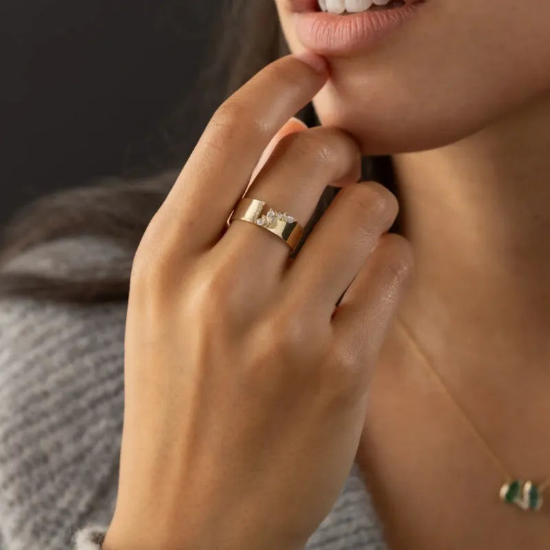 Gold electroplated women's ring with a shining zircon stone on a copper band.