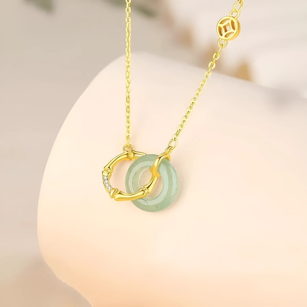 Handmade S925 sterling silver bamboo joint peace buckle necklace with pearl element on adjustable O-ring chain against neutral background