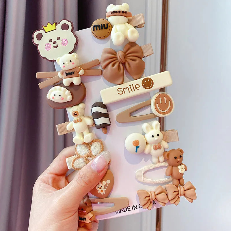 14-piece toddler hair accessories set on display including rainbow barrettes, fruit clips, and butterfly pins in bright colours