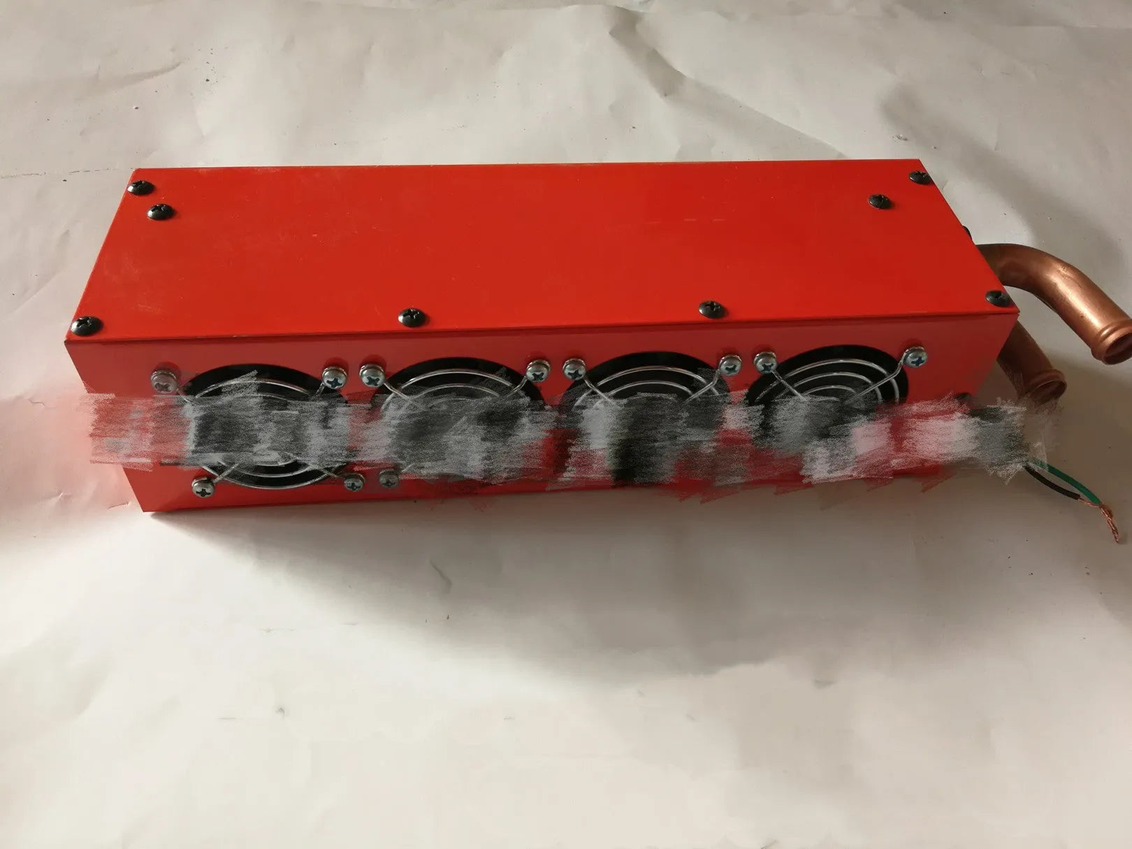 Metal car heater unit with long small four-hole copper pipe for 12V or 24V vehicle installation.