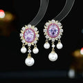 Oval-shaped geometric earrings with zircon inlay and pearl tassels in light purple colour
