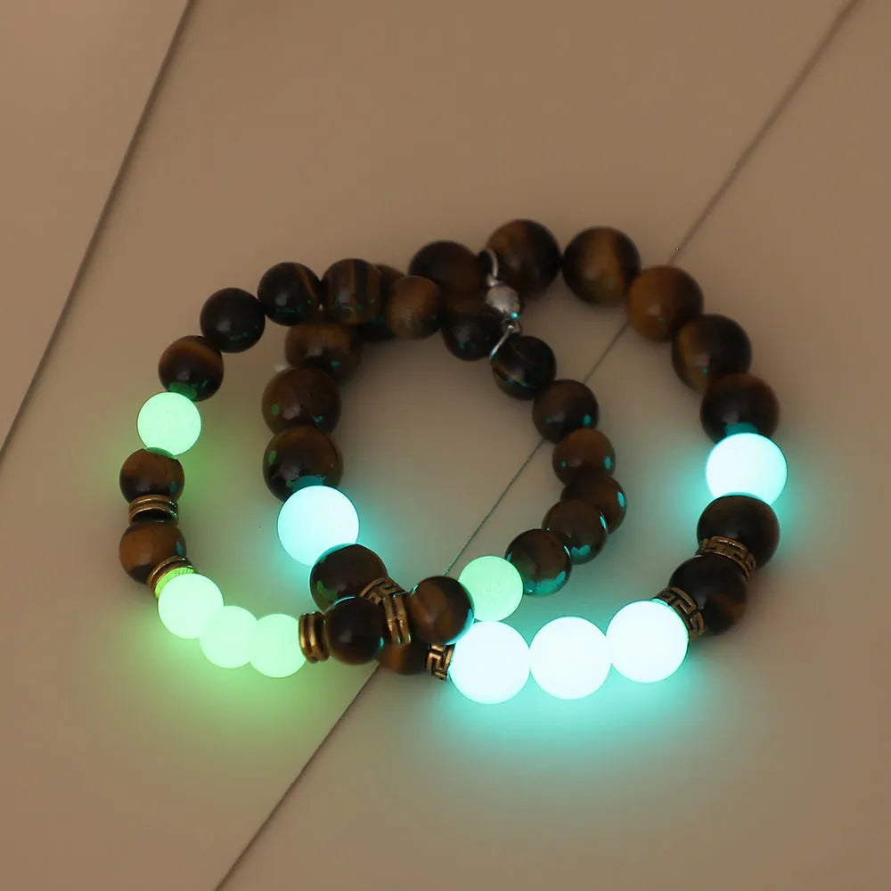 Amber Y552 luminous geometric couple bracelet on dark background showing glow effect