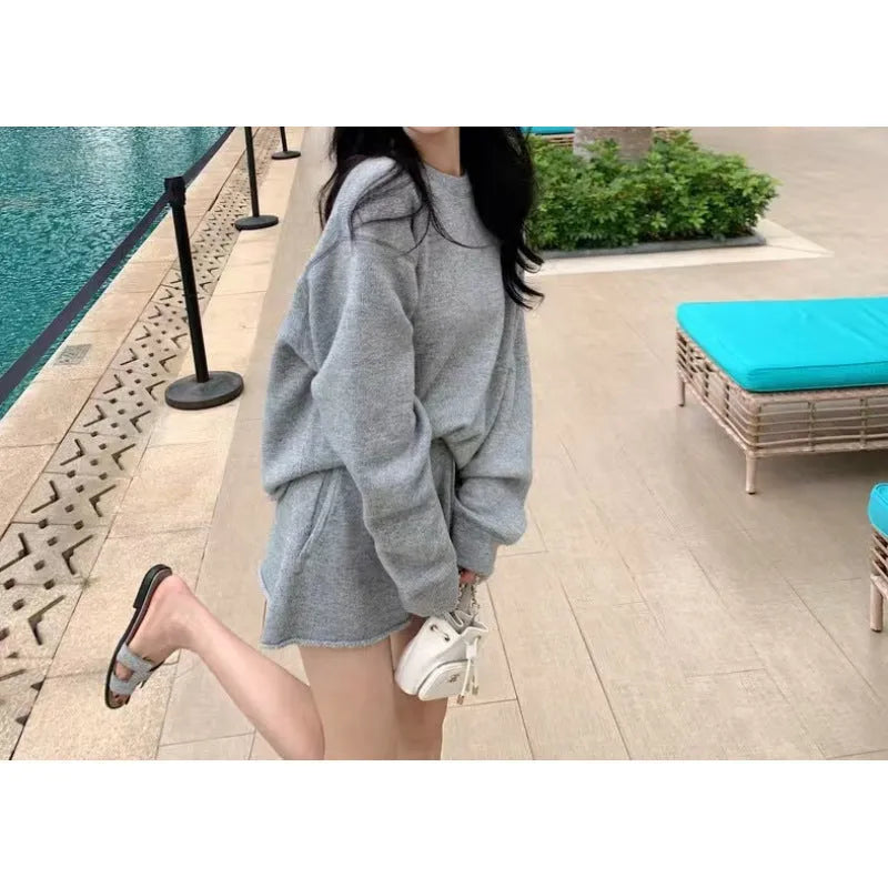 Women's loose-fitting long sleeve sweater and knitted wide-leg shorts co-ord set in dark grey.