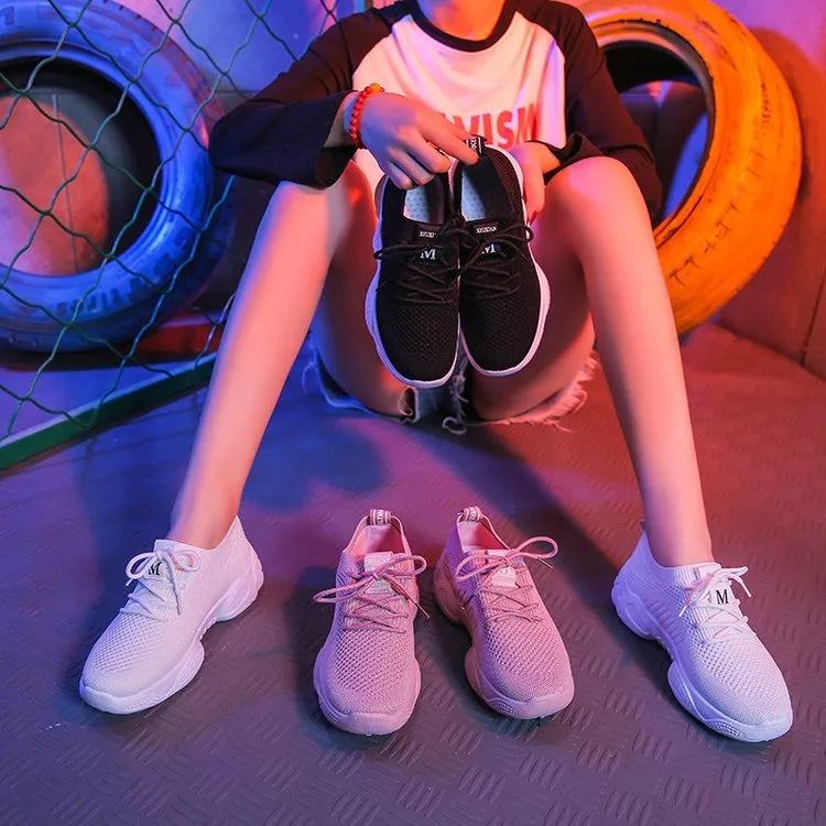 Women's white thick-soled casual sports shoes with flying woven upper and front strap.