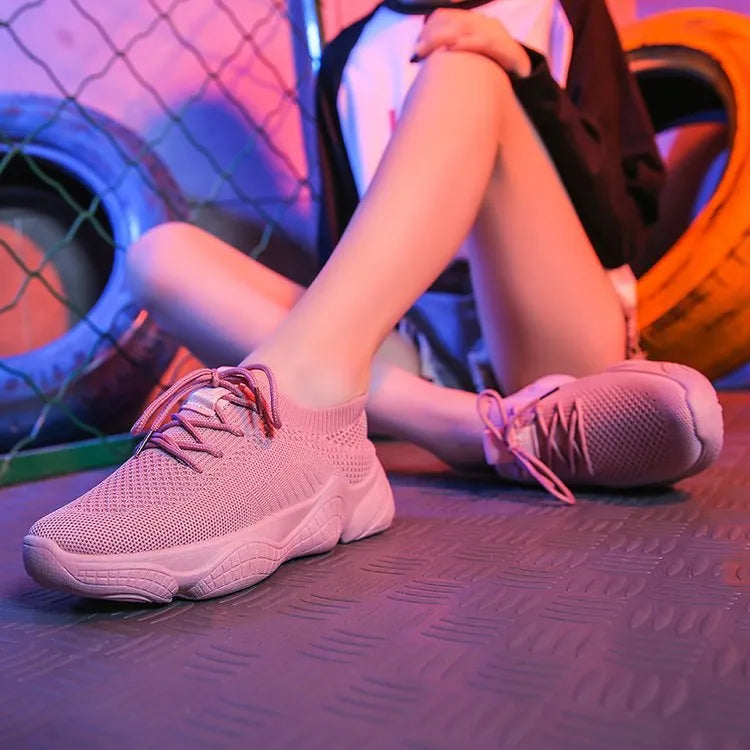 Women's white thick-soled casual sports shoes with flying woven upper and front strap.