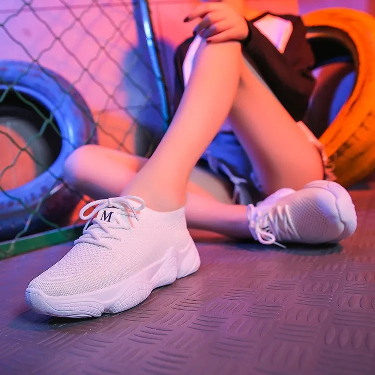 Women's white thick-soled casual sports shoes with flying woven upper and front strap.
