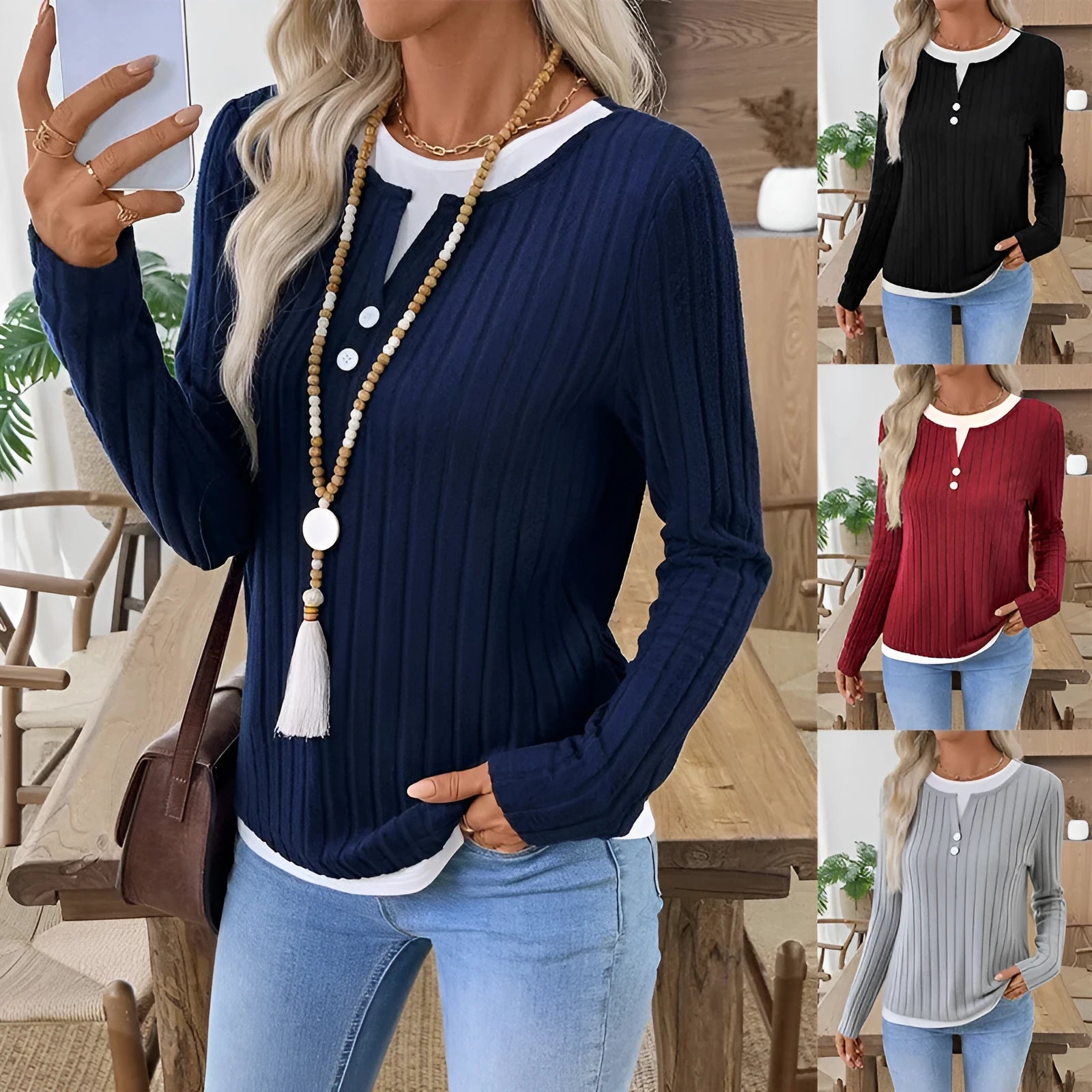Women's black fake two-piece pullover sweater with button front and round neck on a hanger.