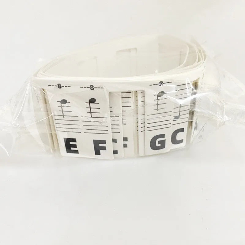 Set of white card piano keyboard stickers for 88 key instruments showing note names and staff notation