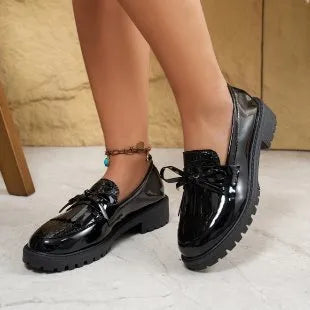 Women's brown loafer shoes with decorative bow detail on synthetic PU upper
