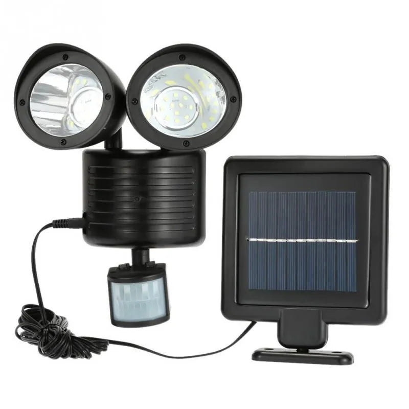 Double head solar induction spotlight in black mounted on a wall showing two LED panels