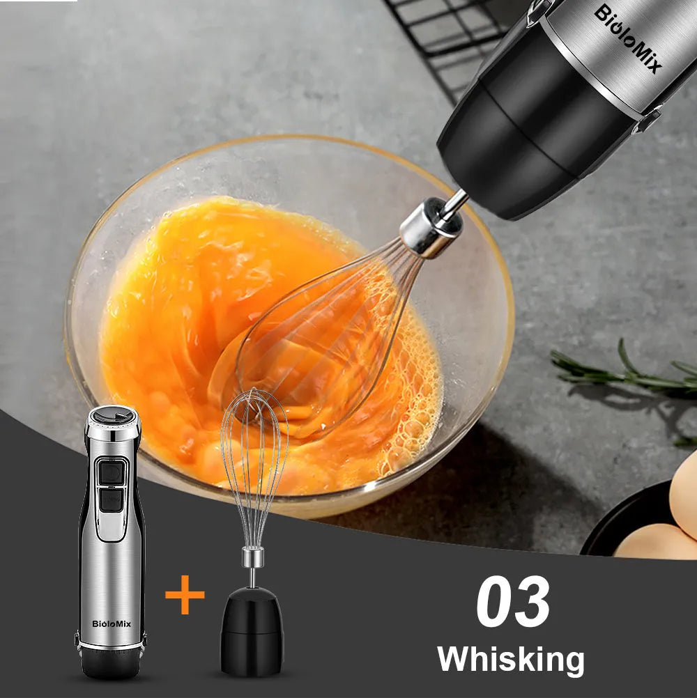 Biolomix stainless steel 4-in-1 hand blender with whisk, chopper bowl, and blending beaker on a black background