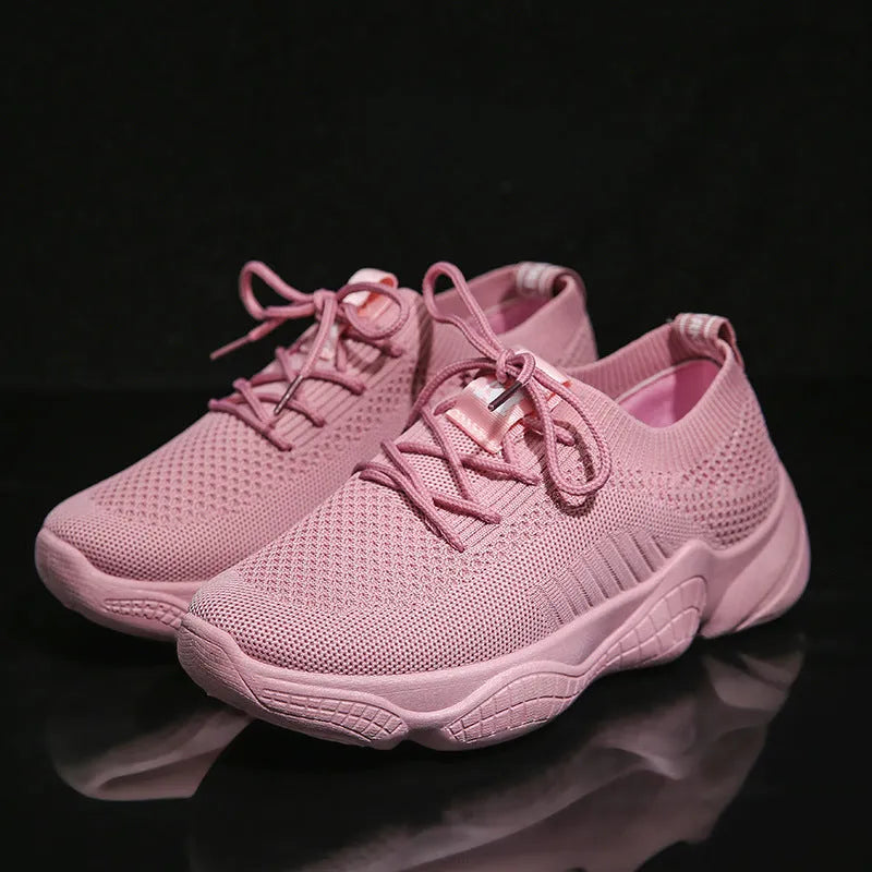 Women's white thick-soled casual sports shoes with flying woven upper and front strap.