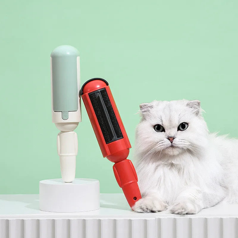 Pet hair remover roller with self-cleaning base, white and green, on a couch