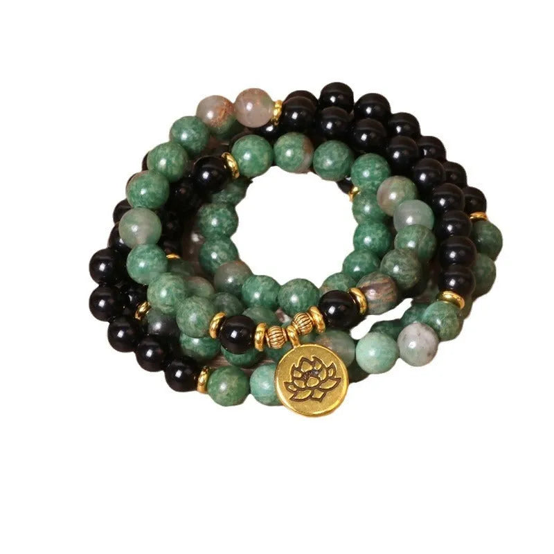 Green and black alloy beaded elastic bracelet laid flat showing alternating colour pattern