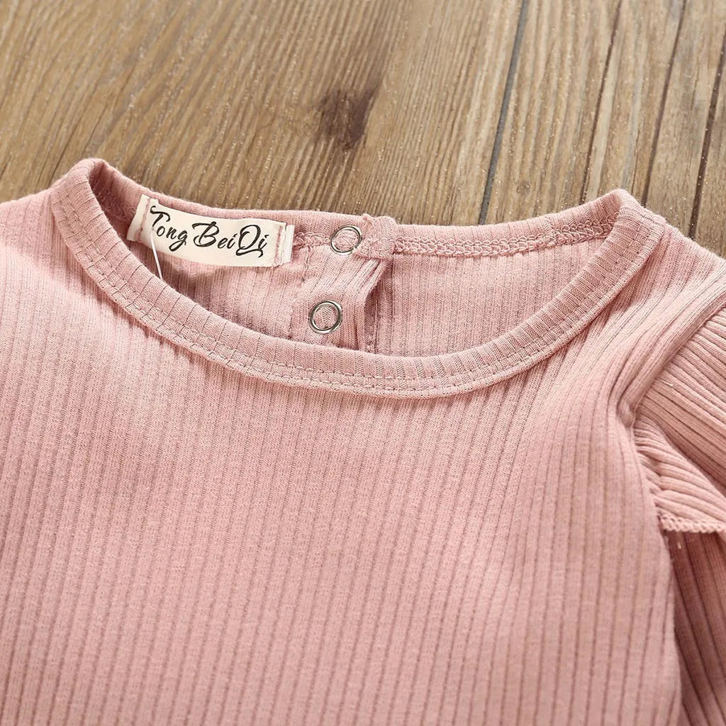 Women's pink cotton long sleeve top with size chart showing bust, length, waist measurements in centimetres