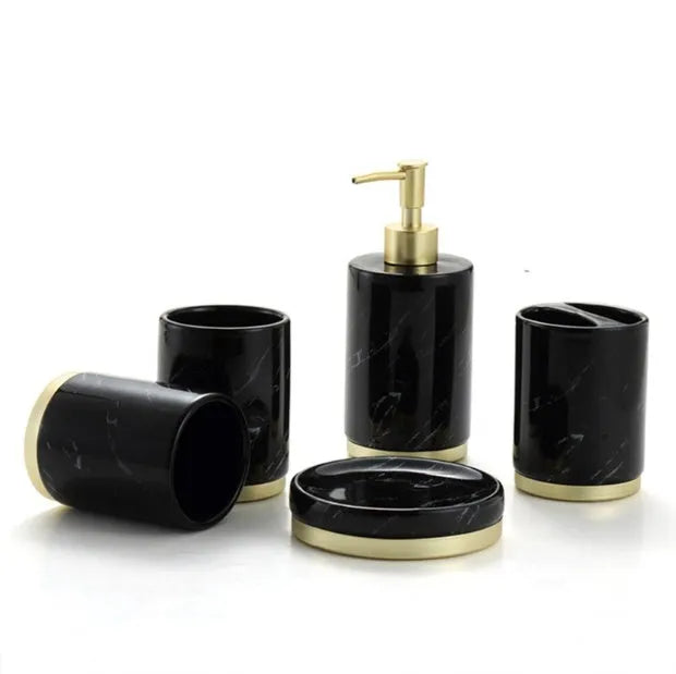 Four-piece ceramic bathroom set with bright glaze finish including bottle, cup, toothbrush holder, and soap dish