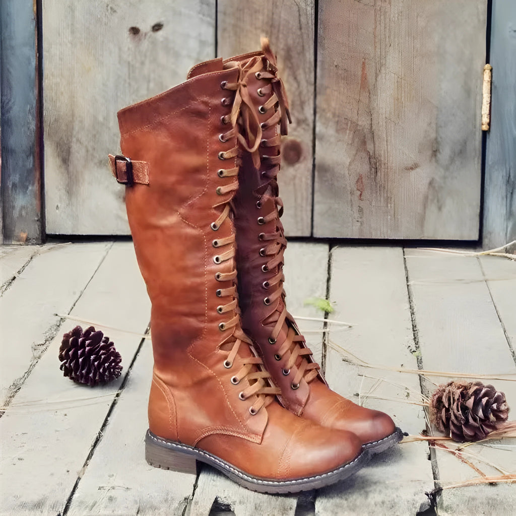 Women's black chunky heel high leg boot with round toe and low stout heel on a solid background.