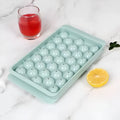 Blue silicone round ice cube tray with lid showing 33 grid design