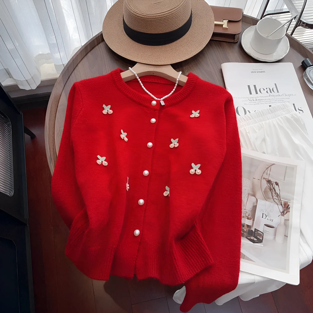 Cashmere blend slim fit cardigan sweater coat with beaded decoration on a hanger.