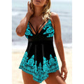 Blue plus size women's swimsuit with deep V neck and printed strap design on a mannequin.