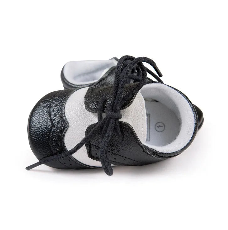 Vintage style soft-soled baby walking shoes in synthetic leather, shown in light brown colour.