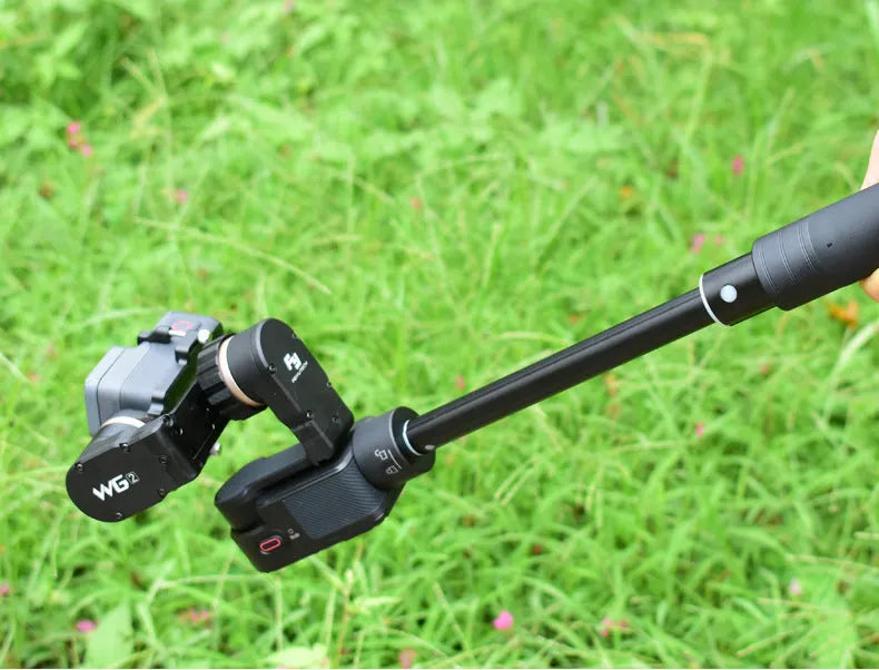 Black retractable aluminium selfie stick extended with phone attached and Bluetooth remote