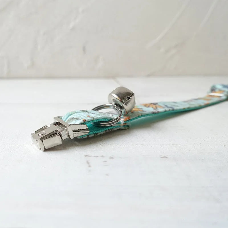 Green adjustable pet collar made of cloth and webbing on a neutral background