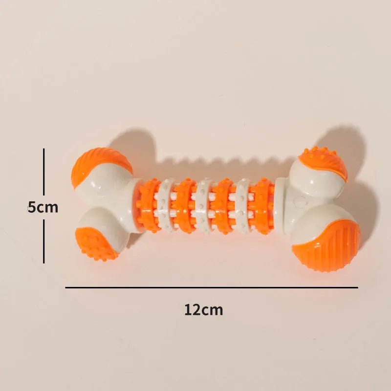 Blue, orange, and red bone-shaped rubber dog chew toy with a treat slot, shown next to dog biscuits.