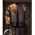Man wearing a black slim-fit PU leather jacket with litchi pattern texture and extended 100cm length