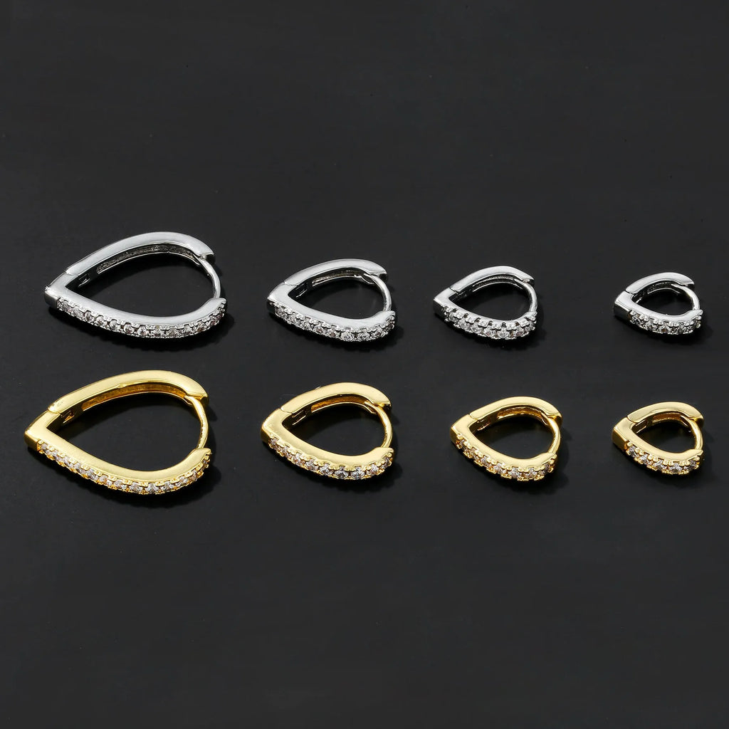 Geometric love heart shaped ear clip in gold electroplated copper on a white background.
