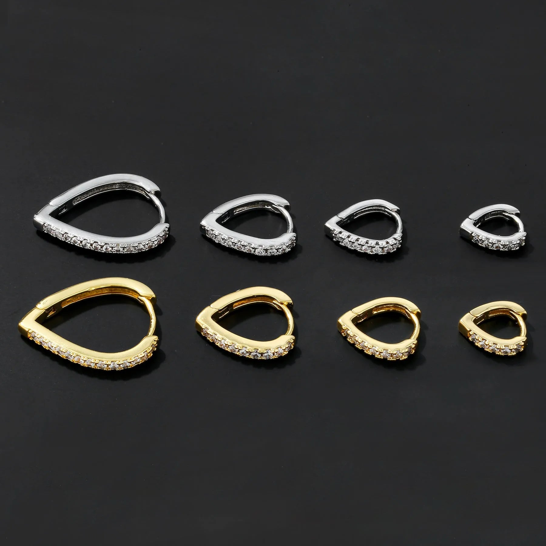 Geometric love heart shaped ear clip in gold electroplated copper on a white background.