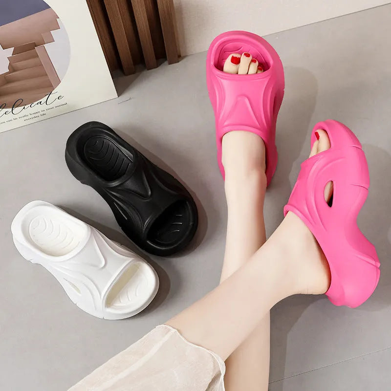 Women's white EVA beach slippers with a thick sole and round toe.