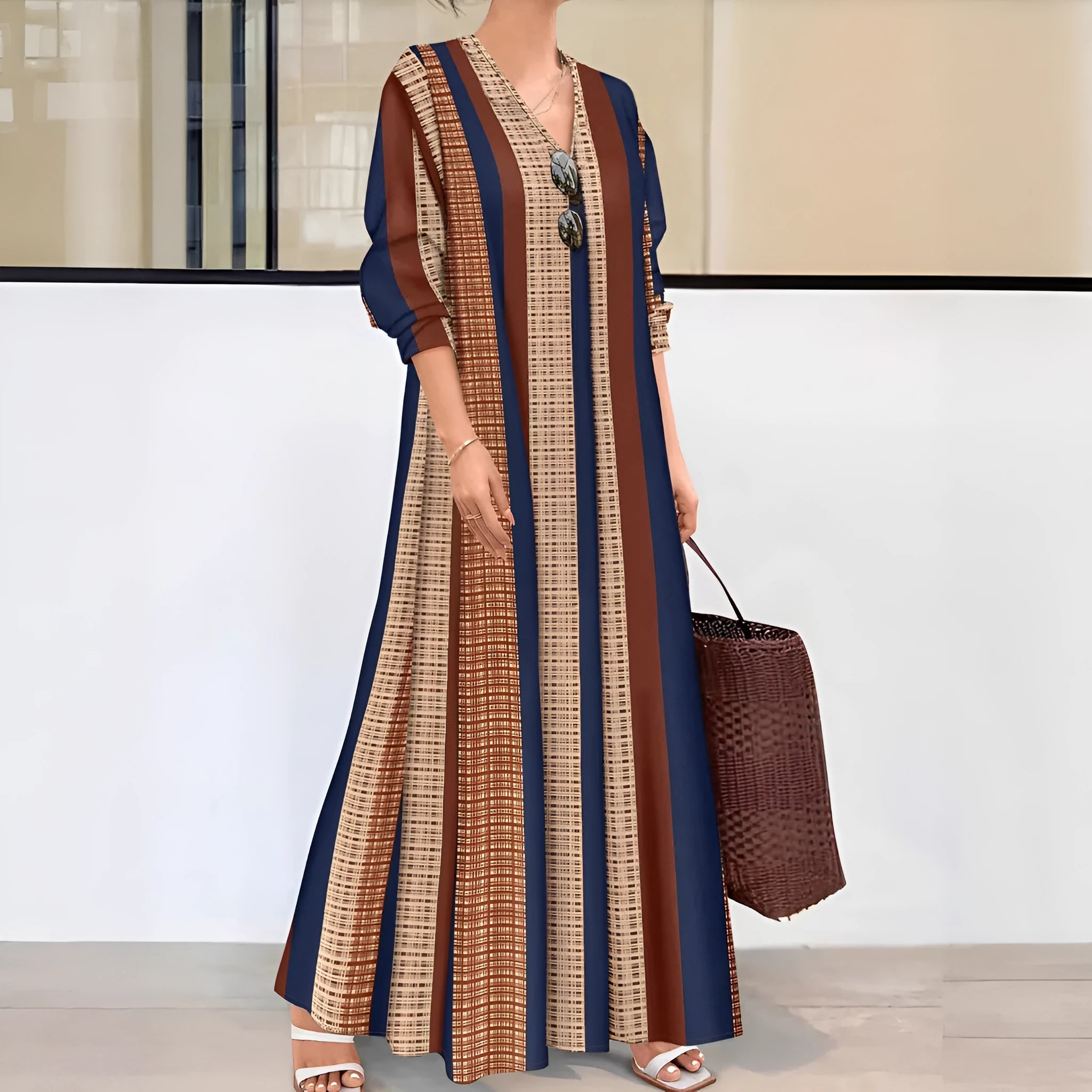 Camel coloured women's V-neck striped dress with long sleeves and an A-line skirt.