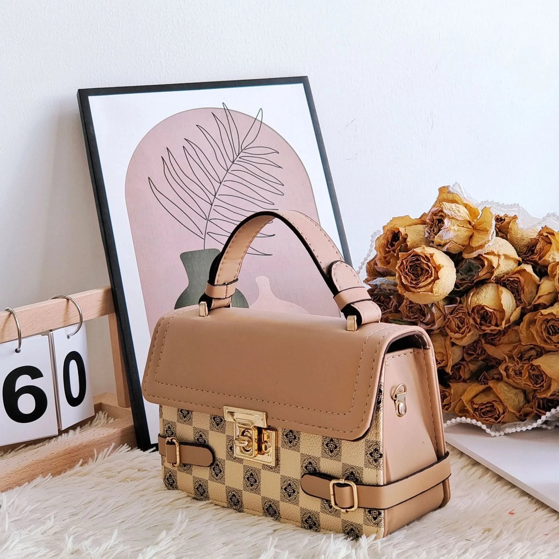 Small square ethnic crossbody bag in apricot PU leather with stitching and plaid patterns.