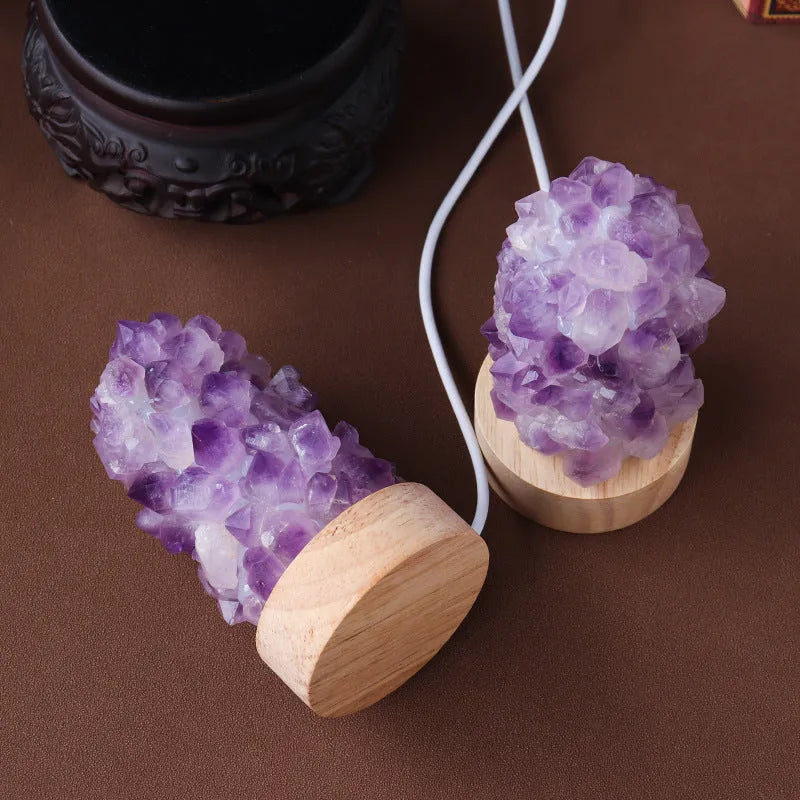 Natural amethyst vug tooth flower mini night light USB plug-in crystal lamp with warm light option on a wooden surface